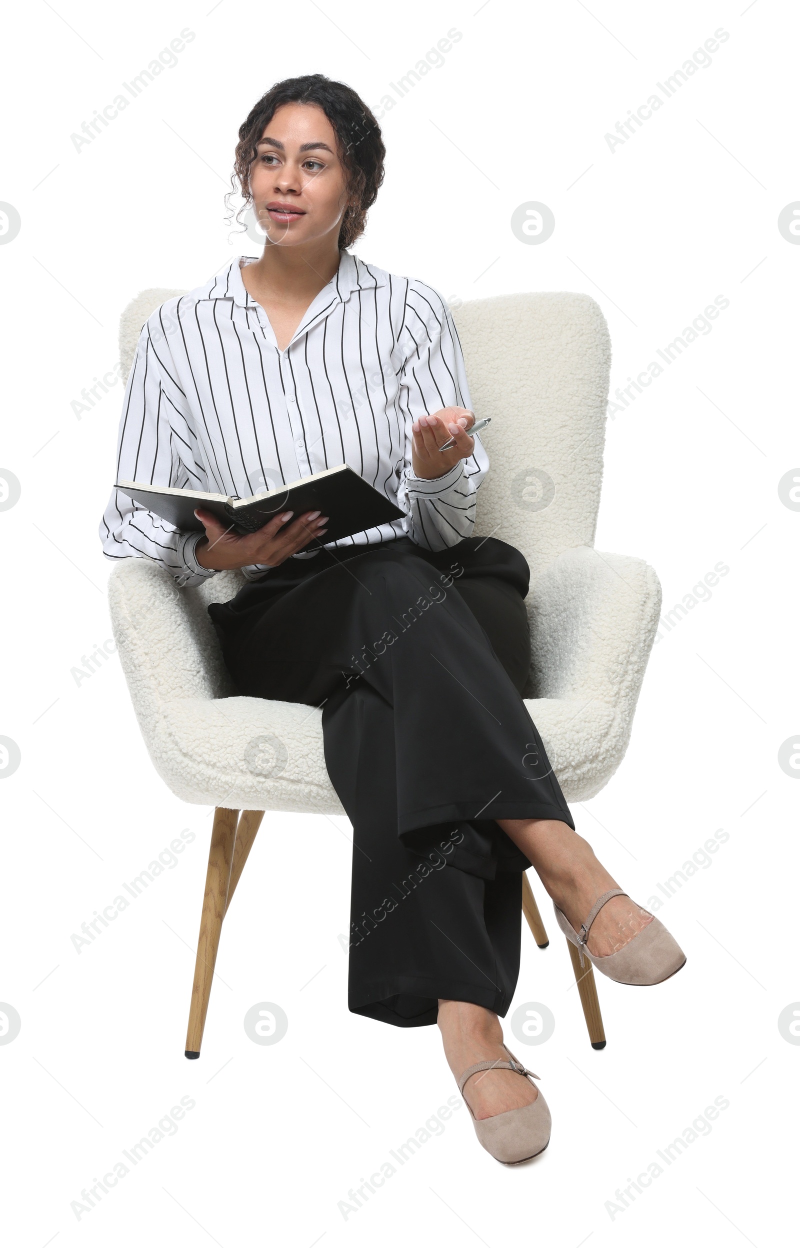 Professional psychologist with notebook and pen in armchair on white background Photo of Professional psychologist with notebook and pen in armchair on white background
