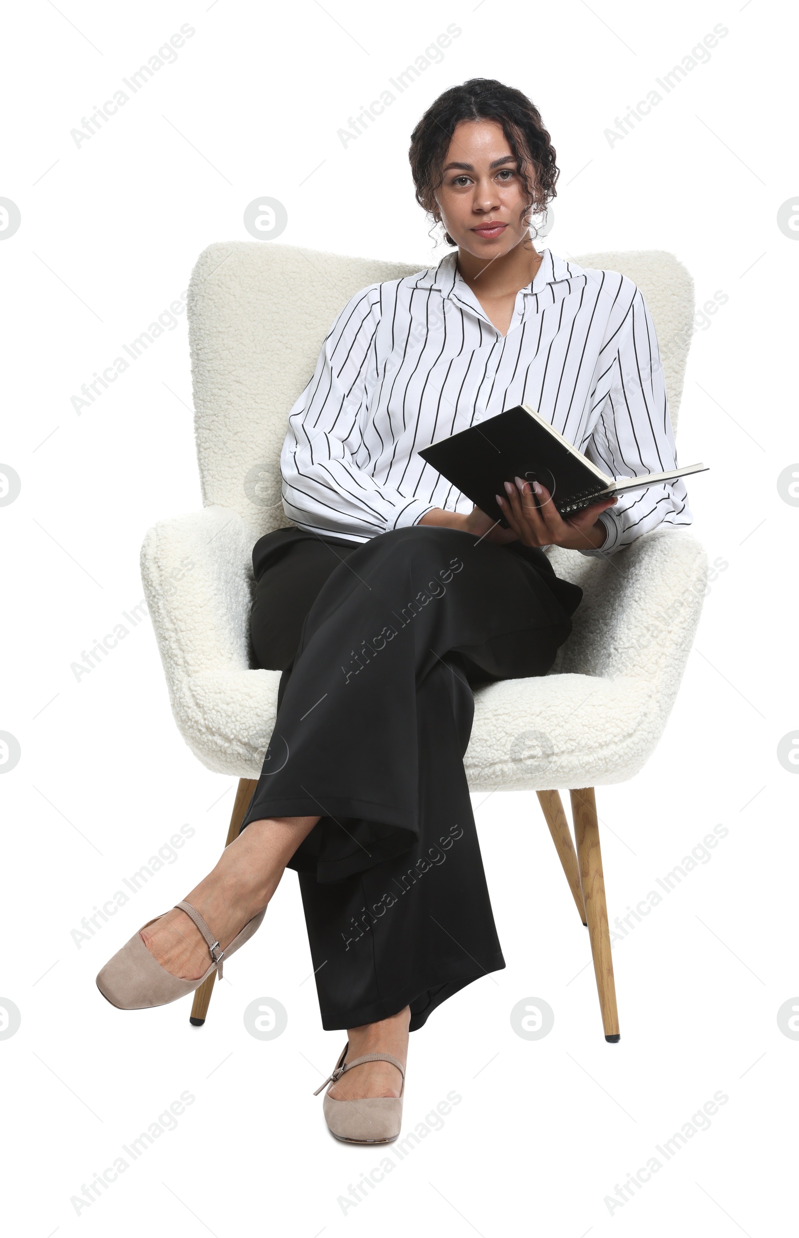 Professional psychologist with notebook in armchair on white background Photo of Professional psychologist with notebook in armchair on white background
