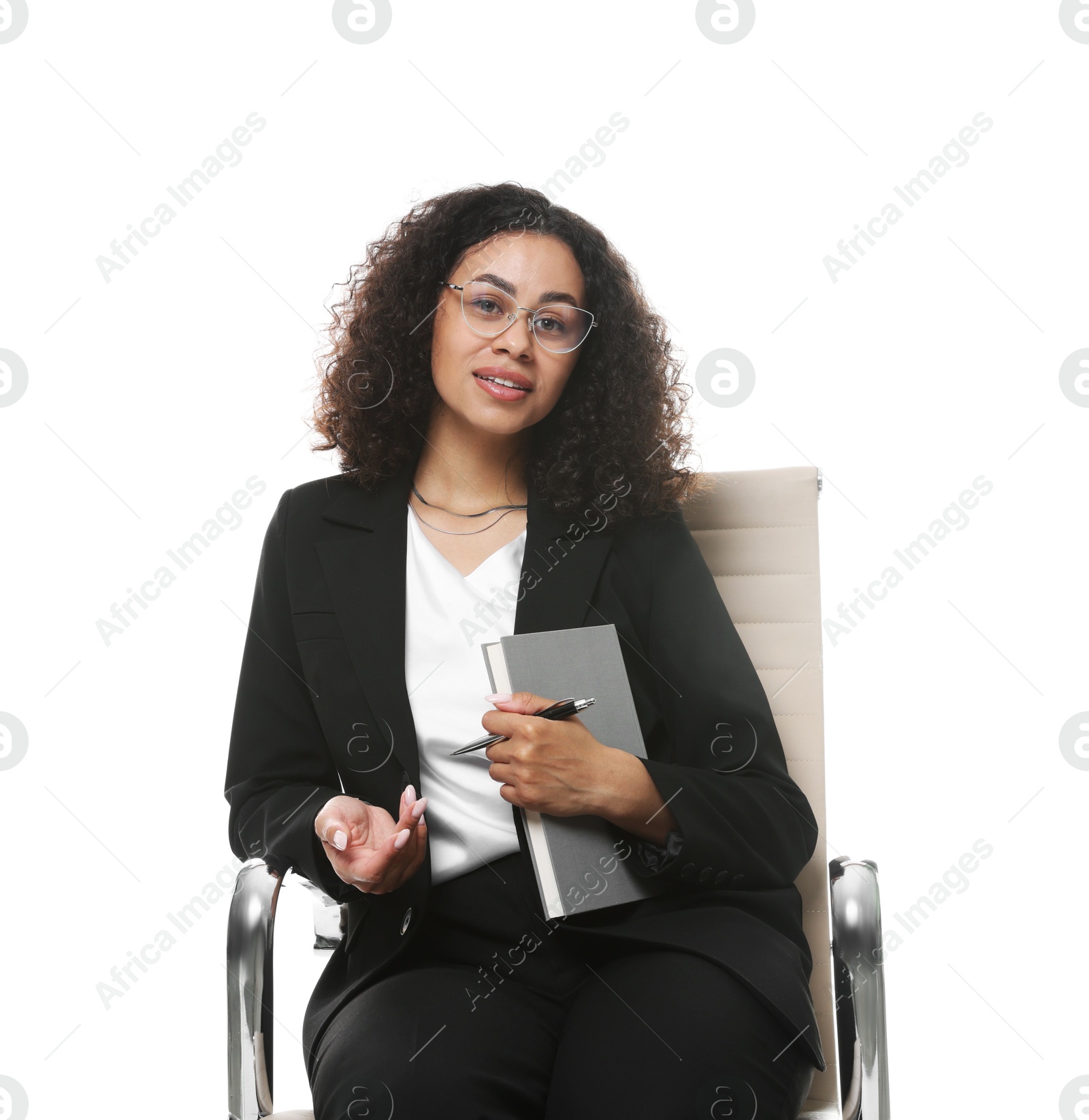 Professional psychologist with notebook and pen in office chair on white background Photo of Professional psychologist with notebook and pen in office chair on white background