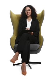 Photo of Professional psychologist with clipboard and pen in armchair on white background