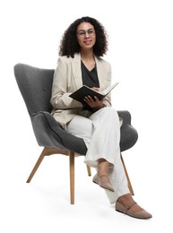 Photo of Professional psychologist with notebook and pen in armchair on white background