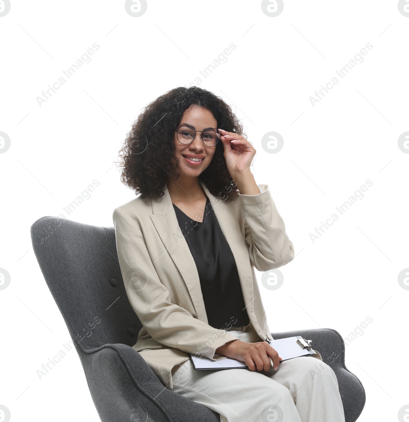 Professional psychologist with clipboard in armchair on white background Photo of Professional psychologist with clipboard in armchair on white background
