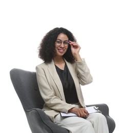 Photo of Professional psychologist with clipboard in armchair on white background