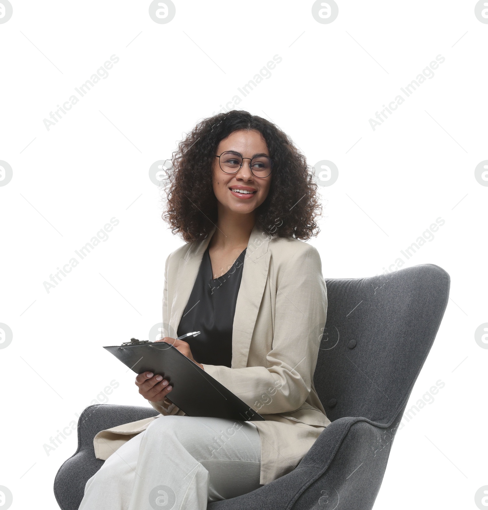 Professional psychologist with clipboard and pen in armchair on white background Photo of Professional psychologist with clipboard and pen in armchair on white background