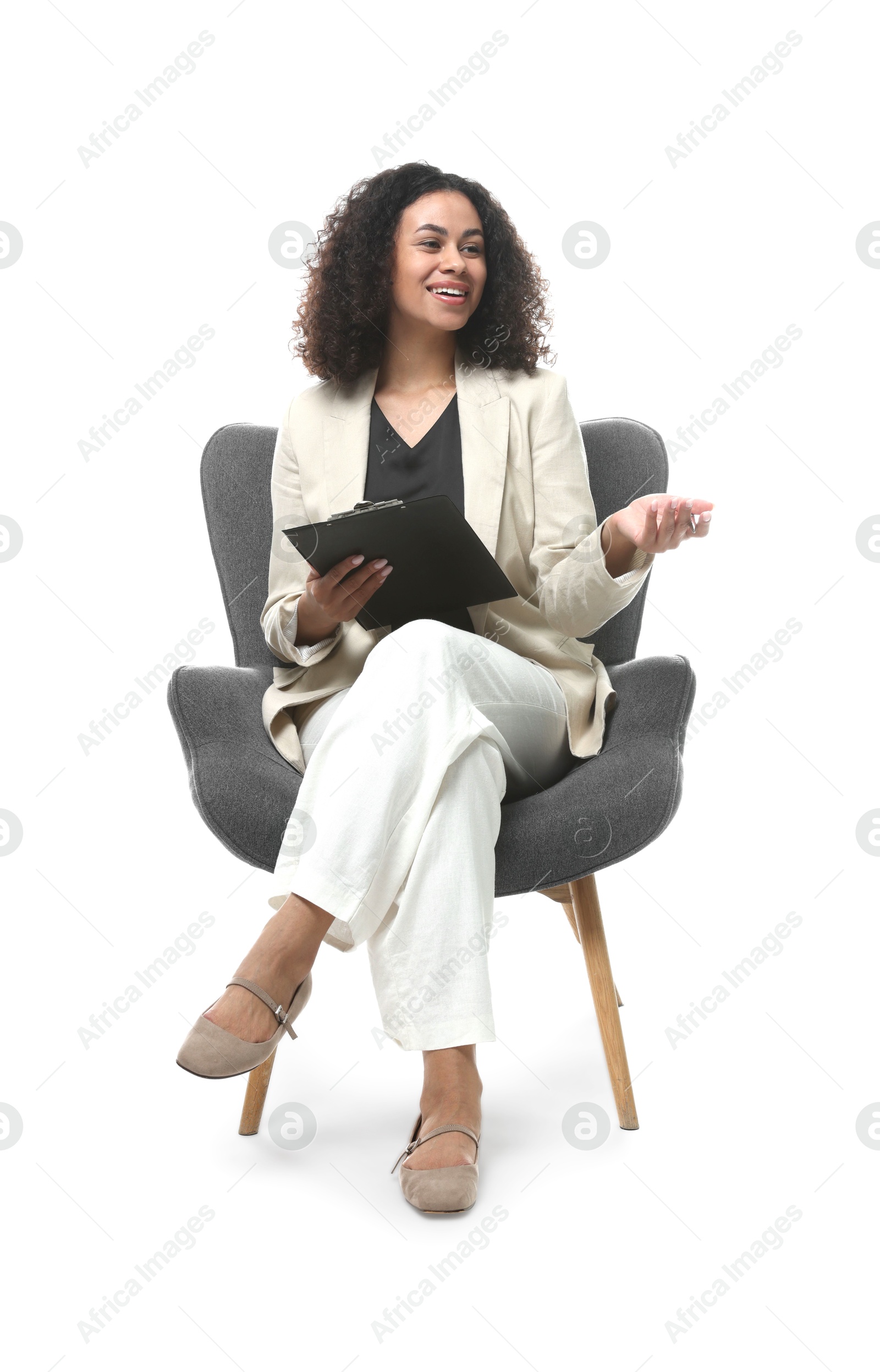 Professional psychologist with clipboard in armchair on white background Photo of Professional psychologist with clipboard in armchair on white background