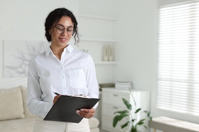Photo of Professional psychologist taking notes in office, space for text