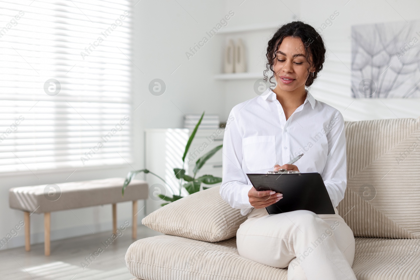 Professional psychologist taking notes in office, space for text Photo of Professional psychologist taking notes in office, space for text