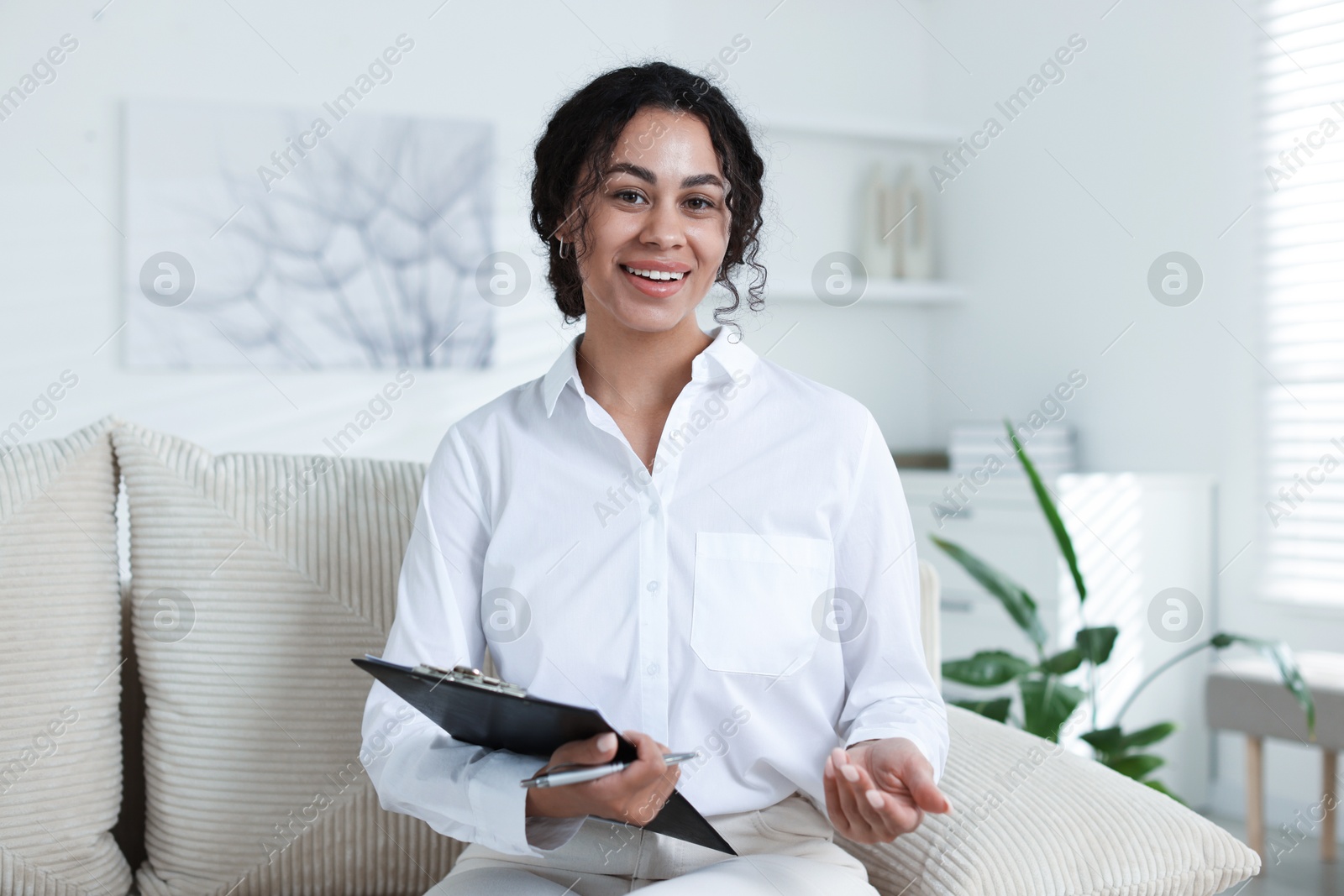 Professional psychologist with clipboard and pen in office Photo of Professional psychologist with clipboard and pen in office