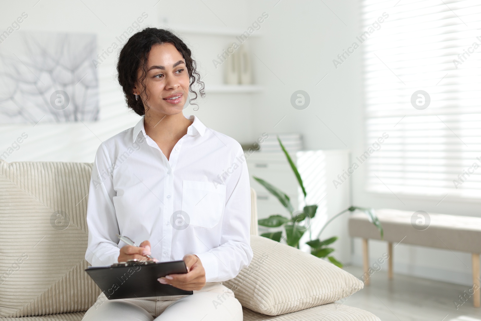 Professional psychologist taking notes in office, space for text Photo of Professional psychologist taking notes in office, space for text