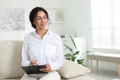 Photo of Professional psychologist taking notes in office, space for text