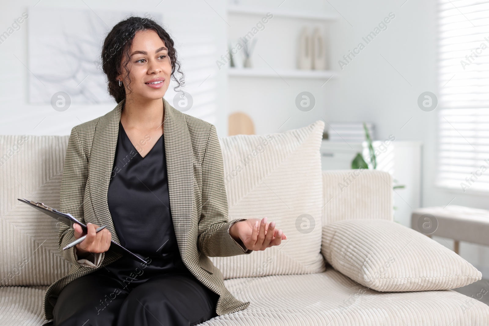 Professional psychologist with clipboard and pen in office, space for text Photo of Professional psychologist with clipboard and pen in office, space for text