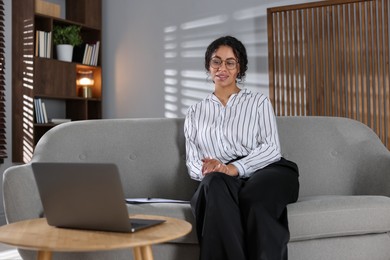 Photo of Professional psychologist working with laptop in office