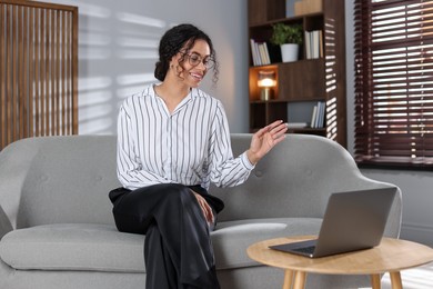 Photo of Professional psychologist working with laptop in office