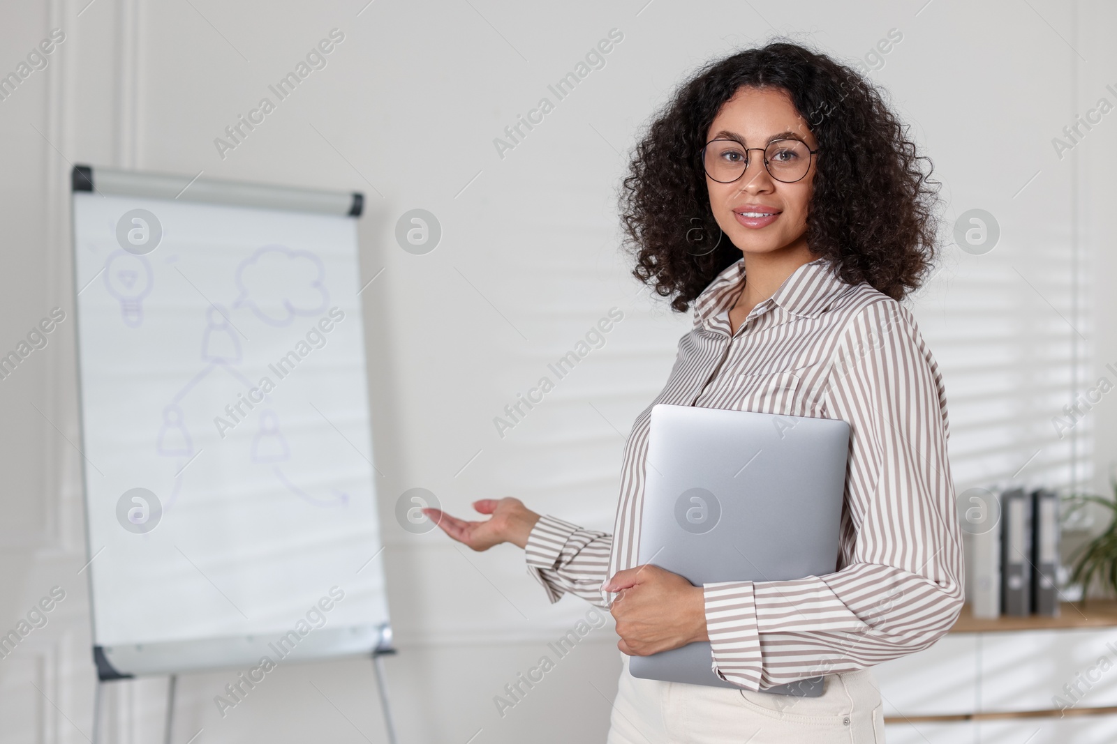 Portrait of professional psychologist with laptop in office Photo of Portrait of professional psychologist with laptop in office