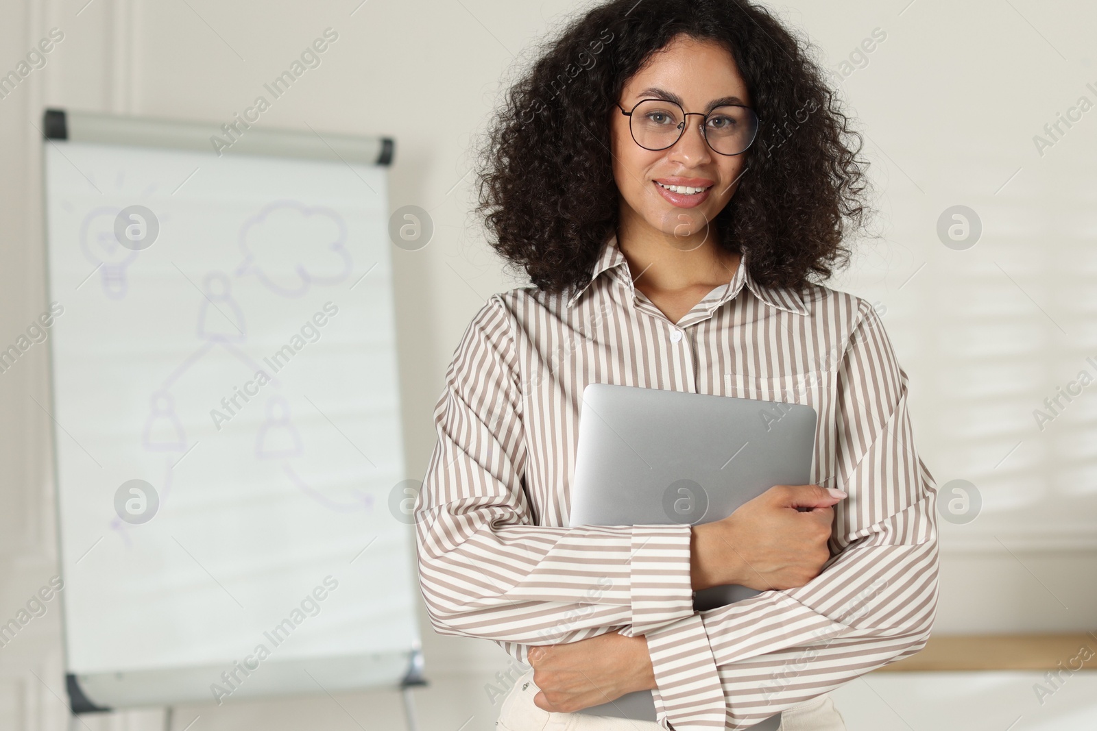 Portrait of professional psychologist with laptop in office Photo of Portrait of professional psychologist with laptop in office