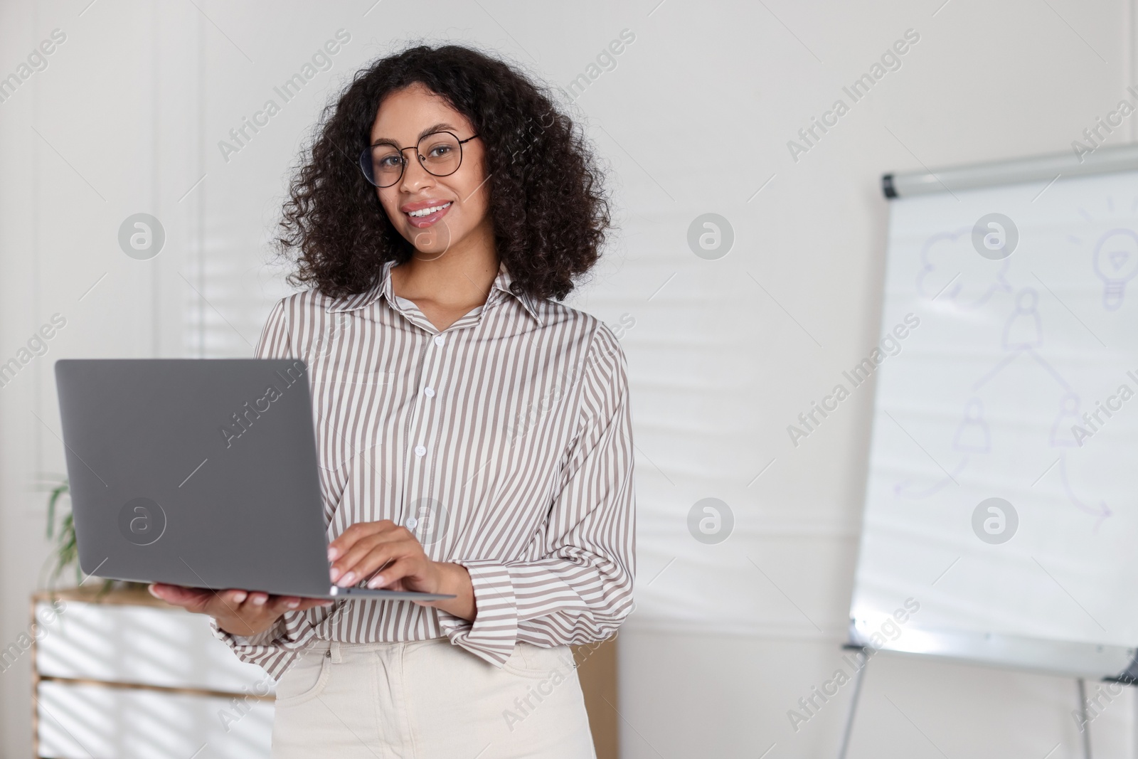 Portrait of professional psychologist with laptop in office, space for text Photo of Portrait of professional psychologist with laptop in office, space for text