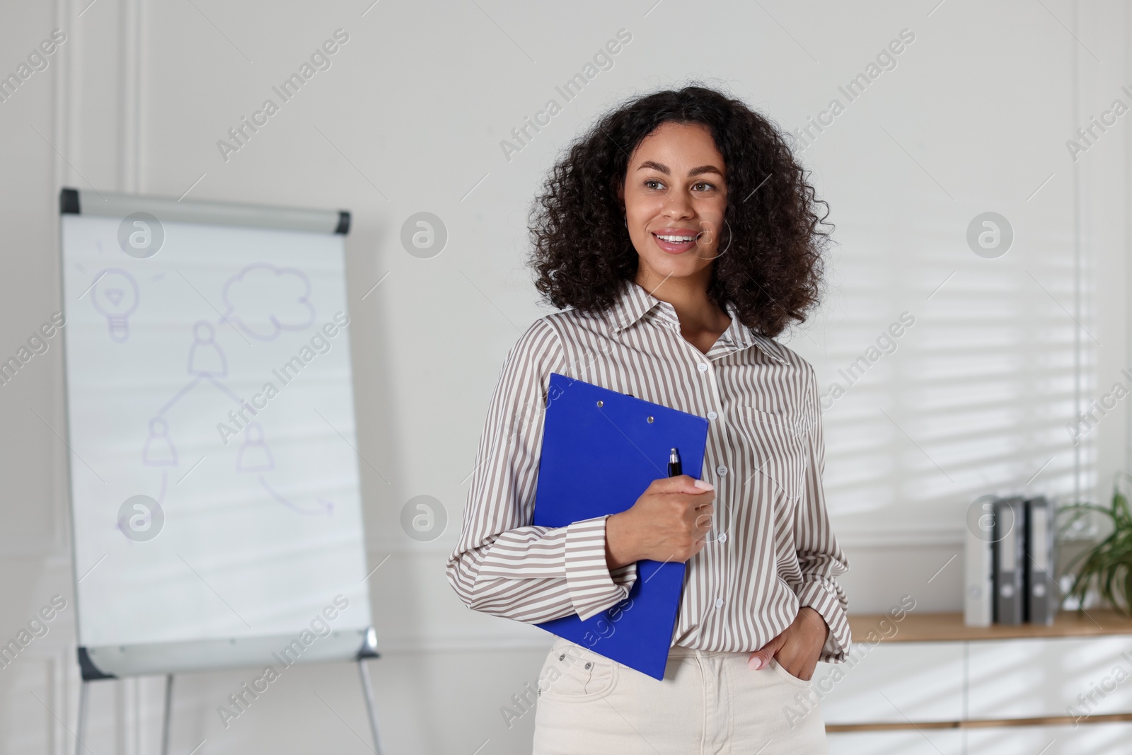Professional psychologist with clipboard and pen in office Photo of Professional psychologist with clipboard and pen in office