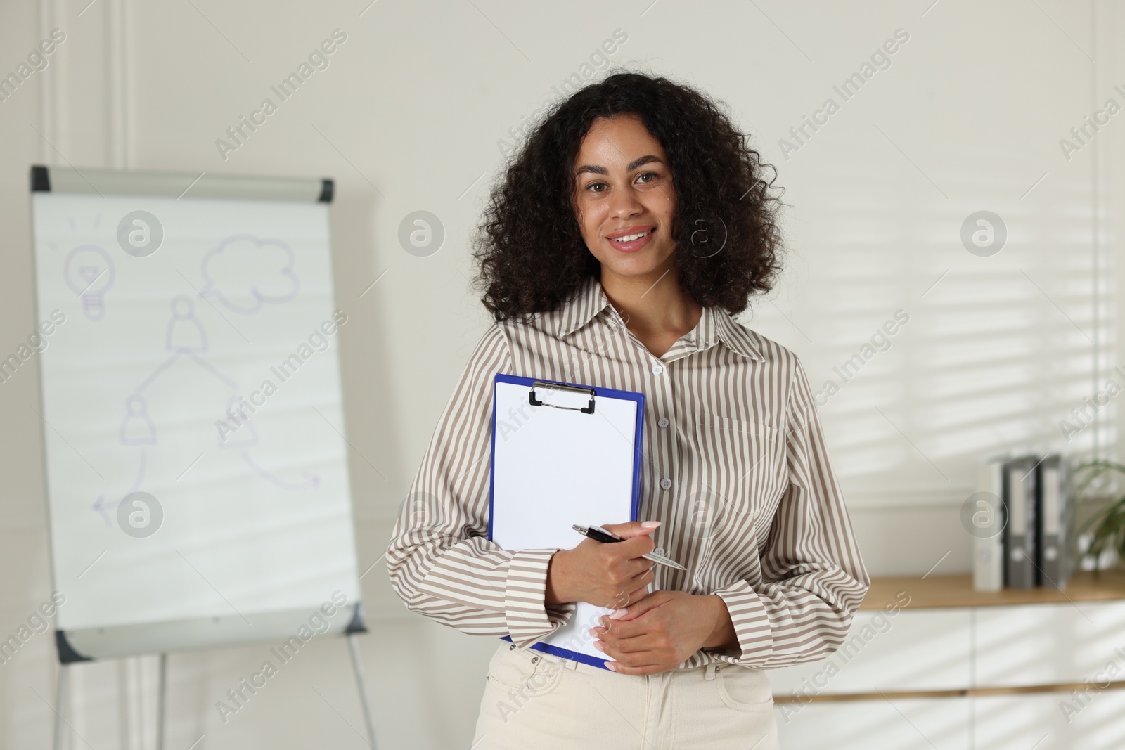 Professional psychologist with clipboard and pen in office Photo of Professional psychologist with clipboard and pen in office