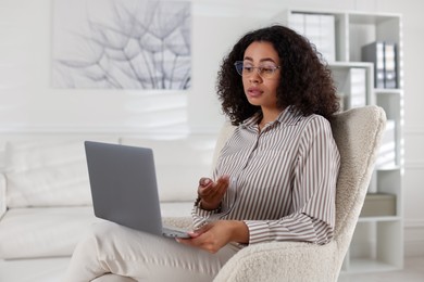 Photo of Professional psychologist working with laptop in office