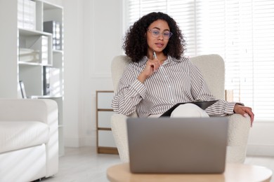 Photo of Professional psychologist working with laptop in office