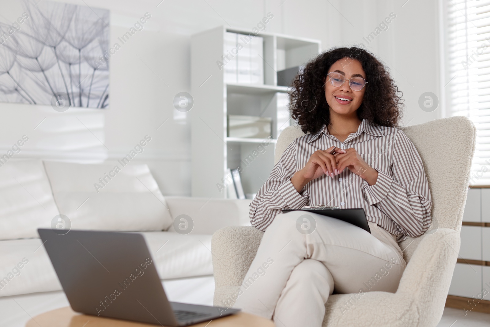 Professional psychologist working with laptop in office Photo of Professional psychologist working with laptop in office