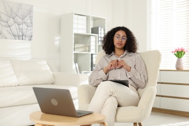 Photo of Professional psychologist working with laptop in office