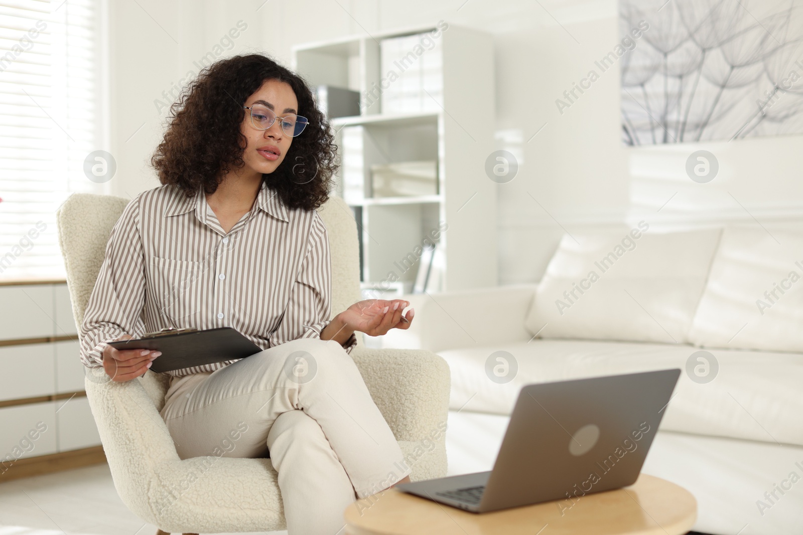 Professional psychologist working with laptop in office Photo of Professional psychologist working with laptop in office