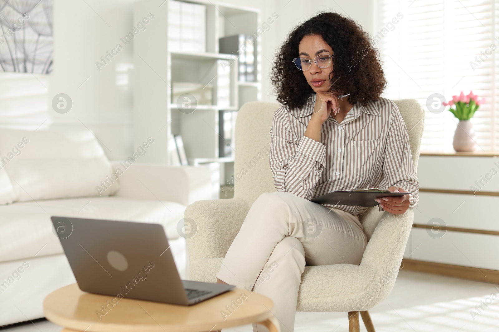 Professional psychologist working with laptop in office Photo of Professional psychologist working with laptop in office