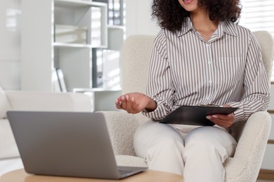 Photo of Professional psychologist working with laptop in office, closeup