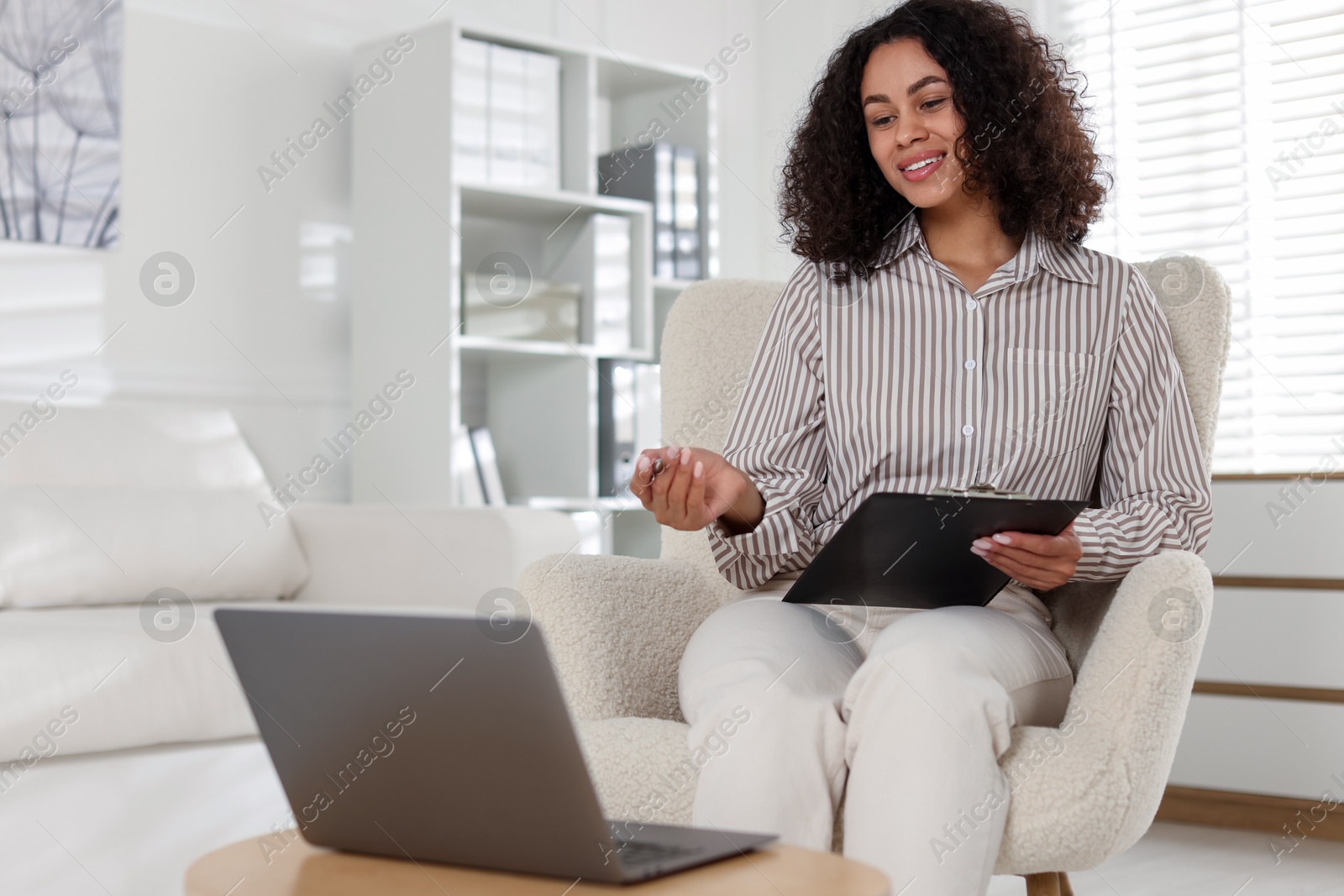 Professional psychologist working with laptop in office Photo of Professional psychologist working with laptop in office