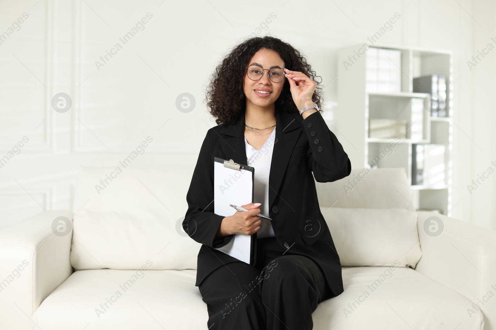 Professional psychologist with clipboard and pen in office Photo of Professional psychologist with clipboard and pen in office