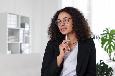 Photo of Professional psychologist with pen in office, space for text