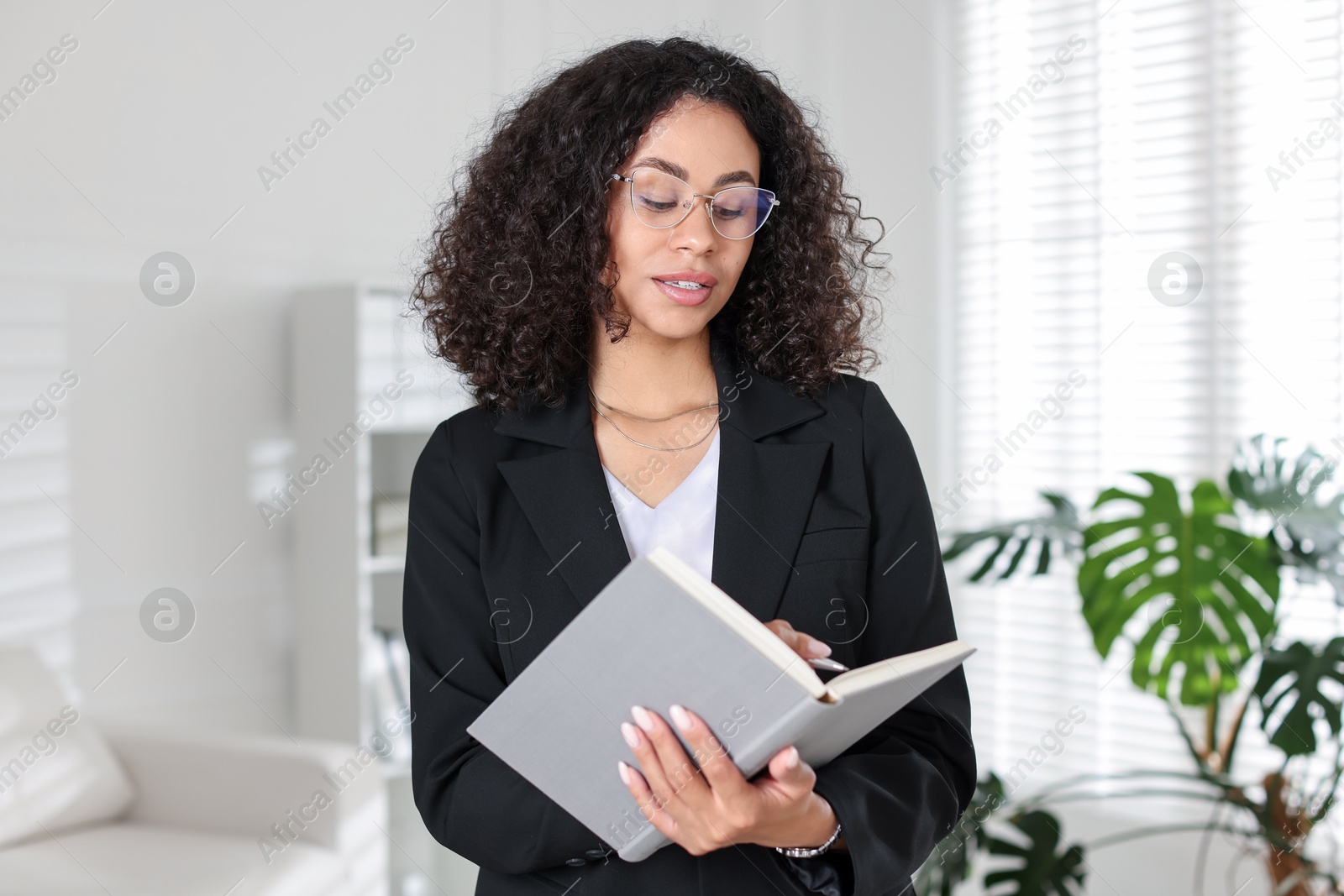 Professional psychologist with notebook and pen in office Photo of Professional psychologist with notebook and pen in office