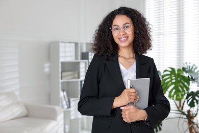 Photo of Professional psychologist with notebook and pen in office, space for text