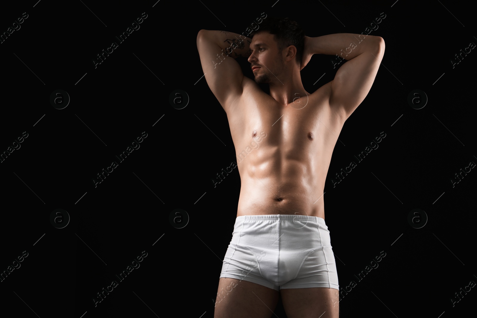 Young man in stylish white underwear on black background. Space for text Photo of Young man in stylish white underwear on black background. Space for text