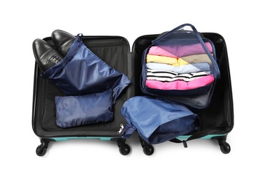 Photo of Open suitcase with packing cubes isolated on white, top view