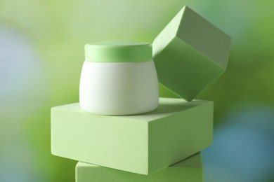 Photo of Stylish presentation of body cream in jar on blurred background, closeup
