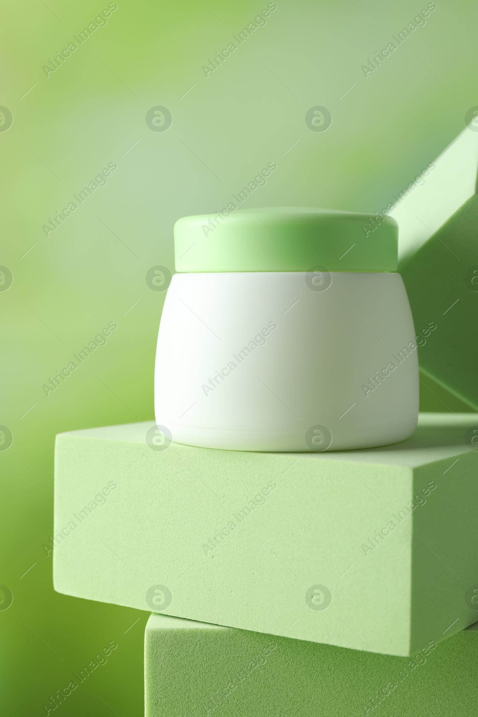 Stylish presentation of body cream in jar on blurred background, closeup Photo of Stylish presentation of body cream in jar on blurred background, closeup