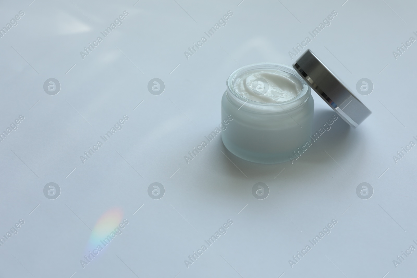 Jar of body cream on white background, space for text Photo of Jar of body cream on white background, space for text