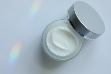 Photo of Jar of body cream on white background, top view