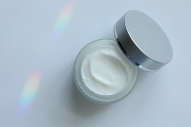 Photo of Jar of body cream on white background, top view