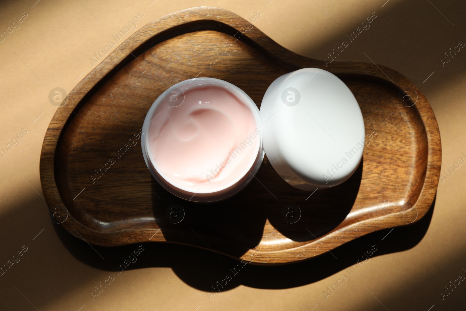 Jar of body cream on beige background, top view Photo of Jar of body cream on beige background, top view