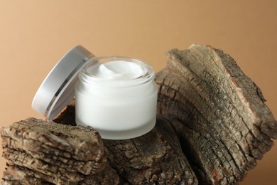 Photo of Jar of body cream on beige background, closeup