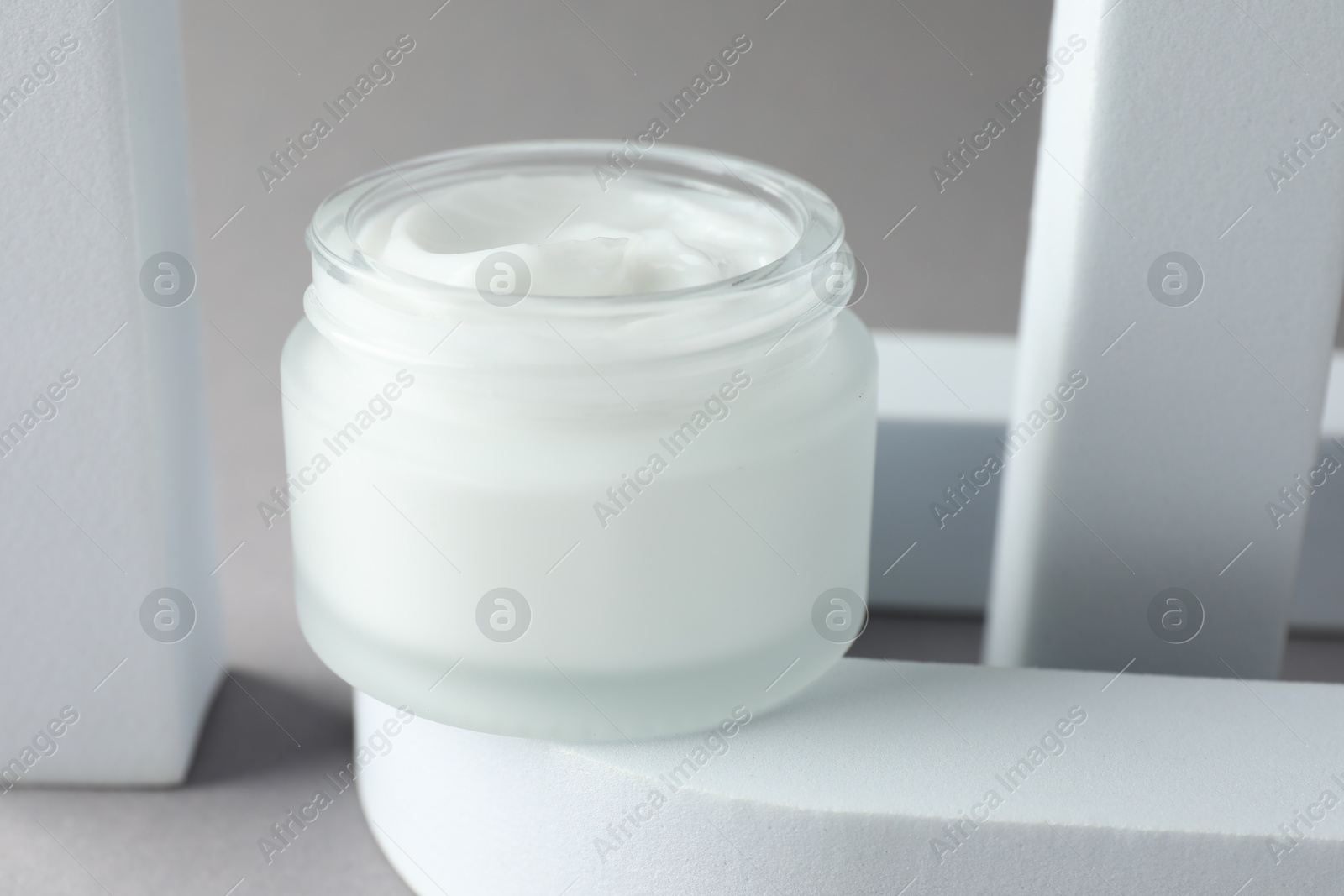 Stylish presentation of body cream in jar on light grey background, closeup Photo of Stylish presentation of body cream in jar on light grey background, closeup