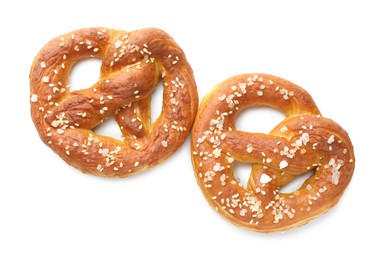 Photo of Tasty pretzels with salt isolated on white, top view