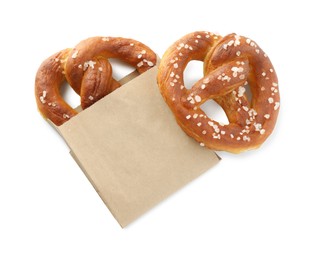 Photo of Tasty pretzels with salt isolated on white, top view
