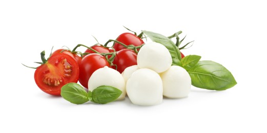 Photo of Tasty mozzarella cheese balls, tomatoes and basil isolated on white