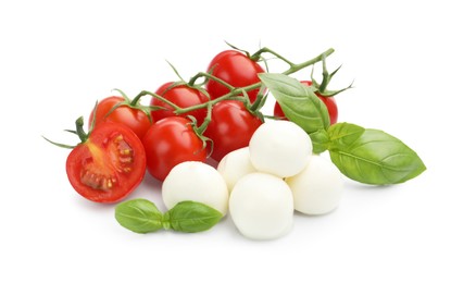 Photo of Tasty mozzarella cheese balls, tomatoes and basil isolated on white