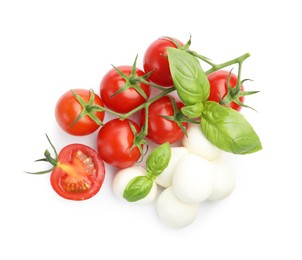 Photo of Tasty mozzarella cheese balls, tomatoes and basil isolated on white, top view