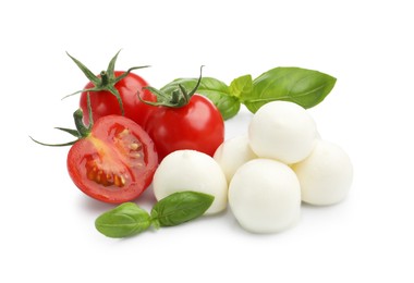 Photo of Tasty mozzarella cheese balls, tomatoes and basil isolated on white